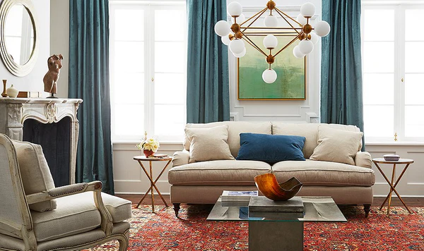 A living room with sofa and table and rug on the floor