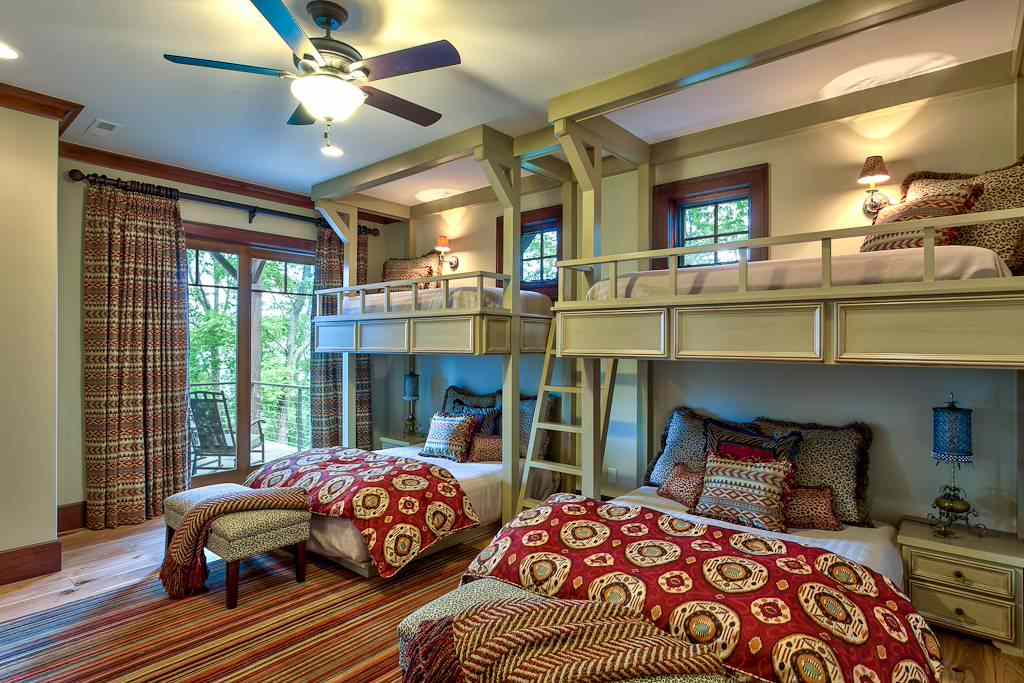 A balcony loft bed and lamp on the table and wooden framed windows