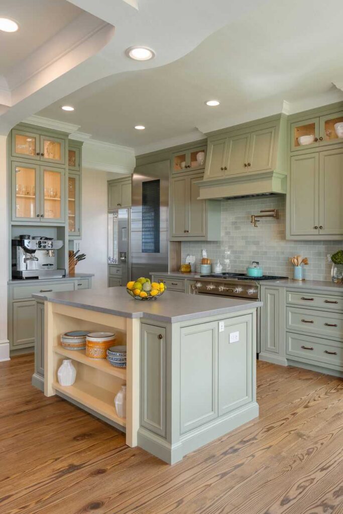 A sage green kitchen with wooden floor and celling lights