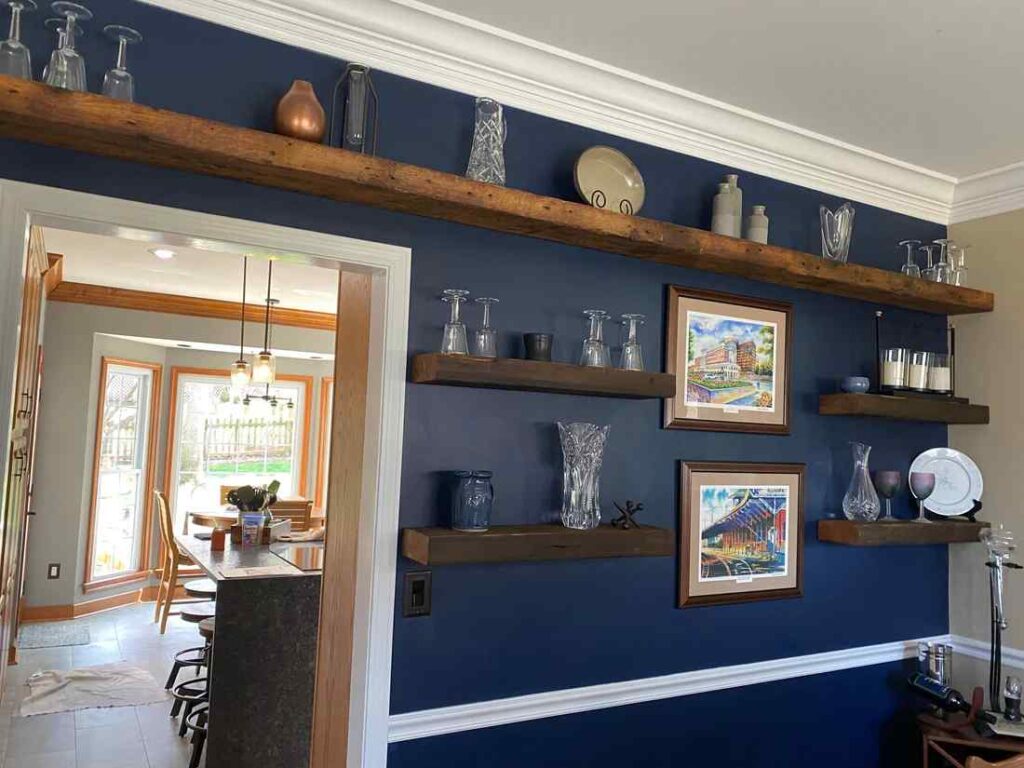 A living room with brown shelves and white trim