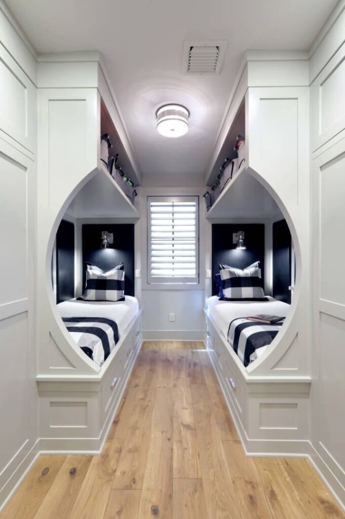 Compact build with beds in bedroom with wooden floor 