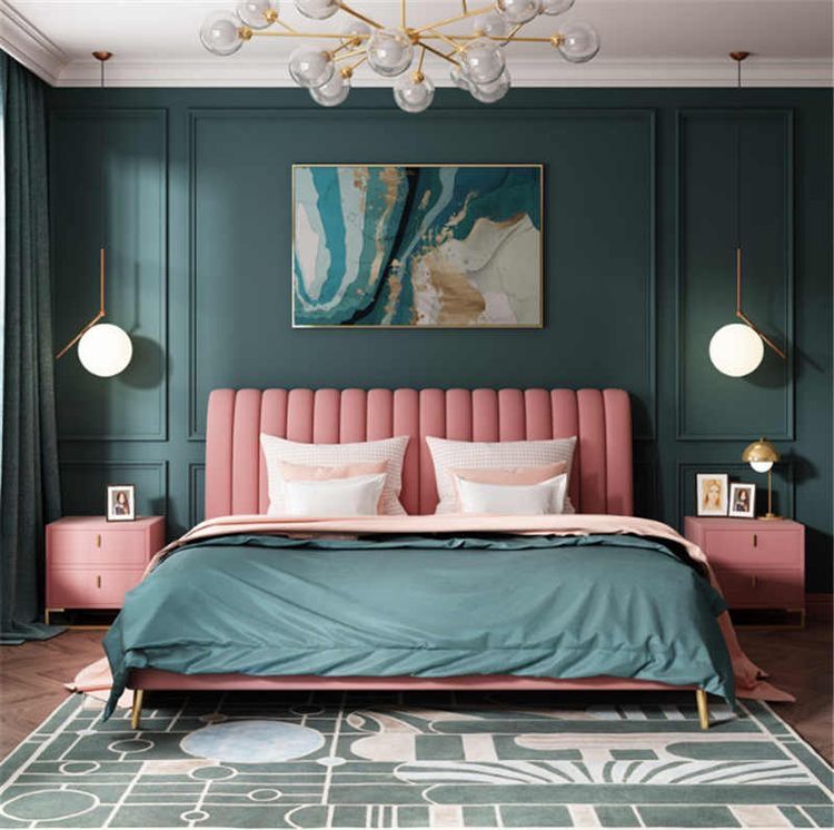 A green bedroom with green molding and pink bed and nightstand