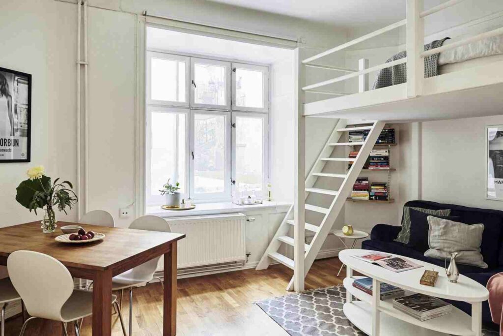 A under-seating loft bed and study table and wooden floor and sofa and table