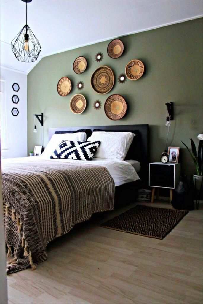 A sage green bedroom with black accents
