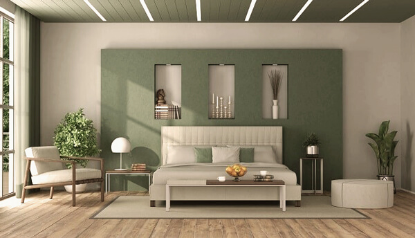 A sage green with contrast with taupe with bed and chair and wooden floor 