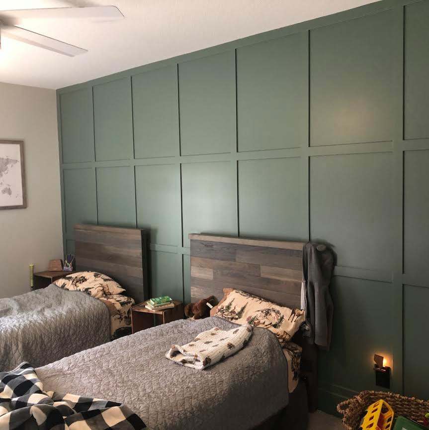 A olive green board and bitten wall
