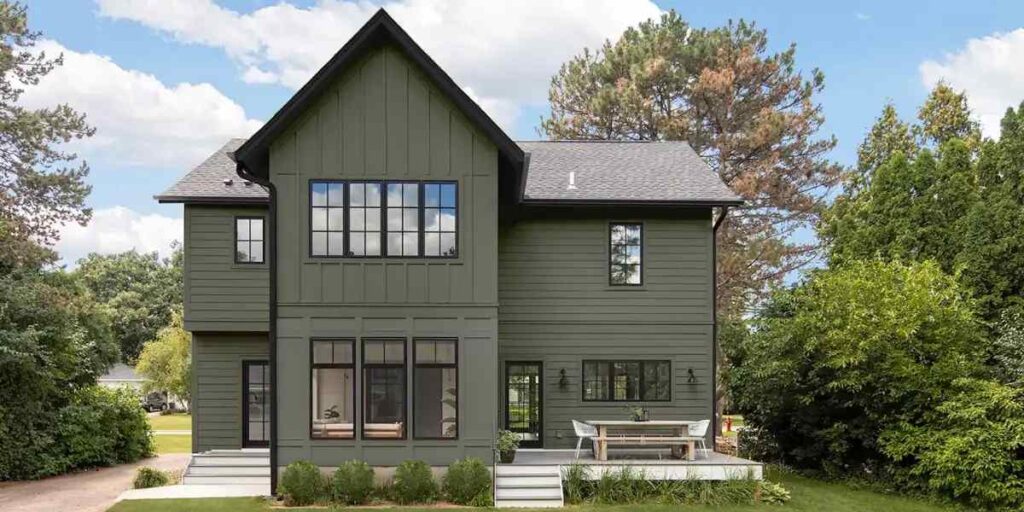 Dark green house with black trim and black roof