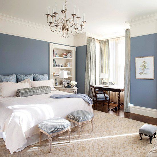 A bedroom with bed and white blankets and pillows and beige accents