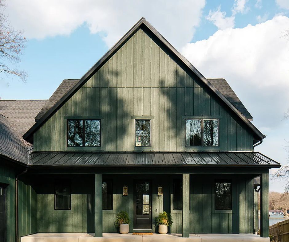 Dark green home with black metal  patio and black window