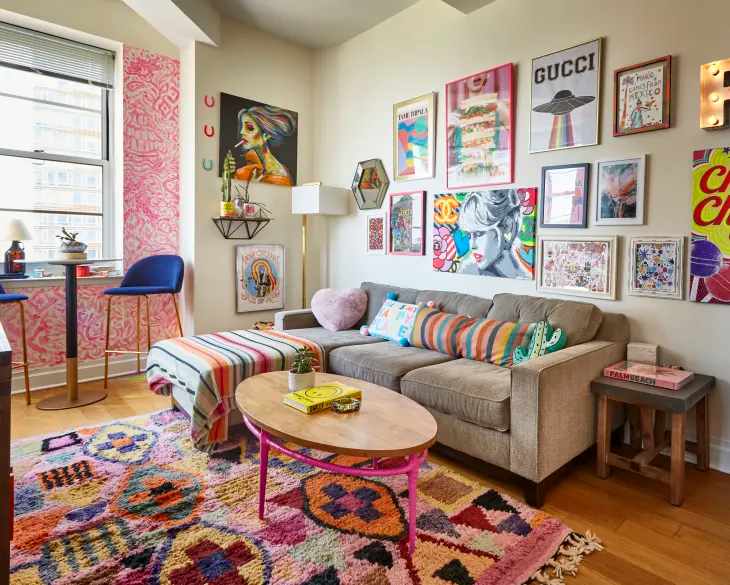 A living room with Eclectic textiles and sofa and cushion on it and wooden floor 