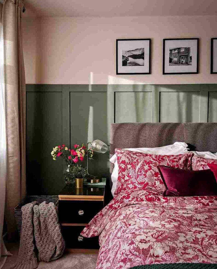 A pink and green wall and bed and side nightstand