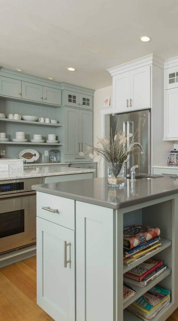 A sage green vanity with grey countertop in kitchen