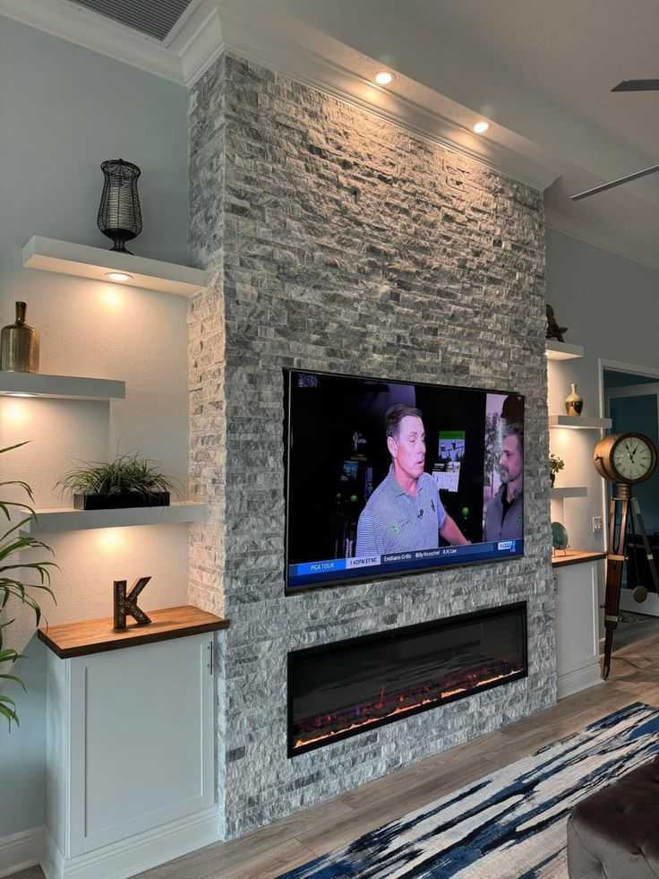 A living room with grey stone fire place 