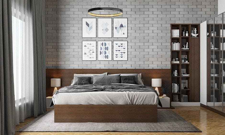 A bedroom with wooden floor and brick wall and book wooden shelves