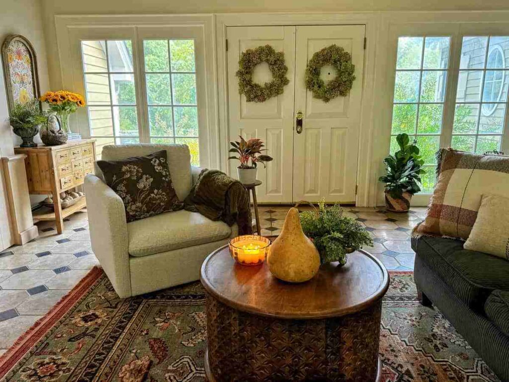 A living room with sofa and wooden table and floor and windows