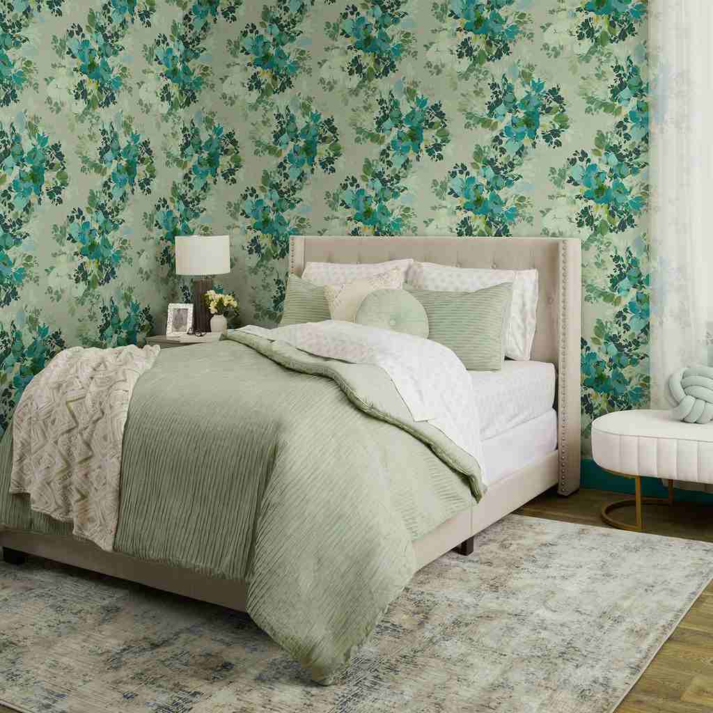 A sage  green bedroom with wallpaper and wooden floor and rug 