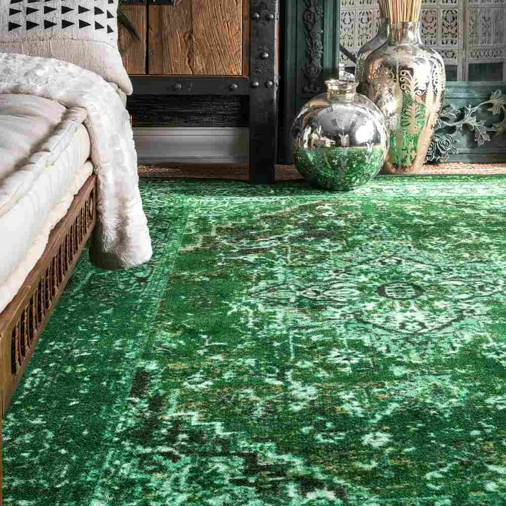 A rug on the wooden floor and bed 