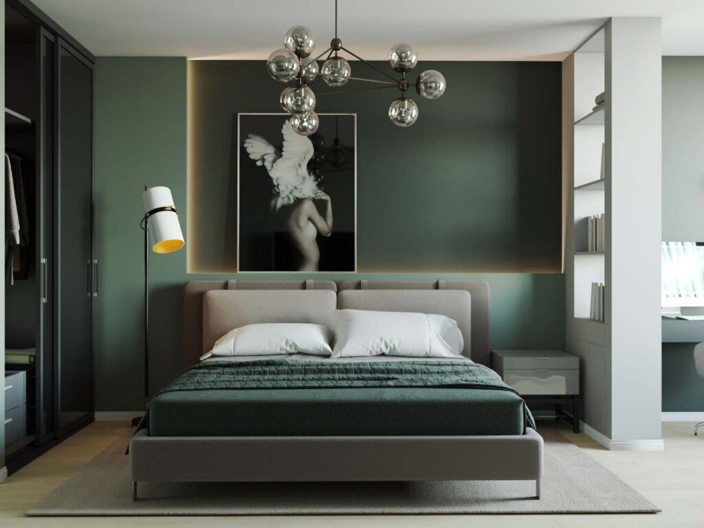 A green bedroom with painting above the bed and wooden foor with rug on it