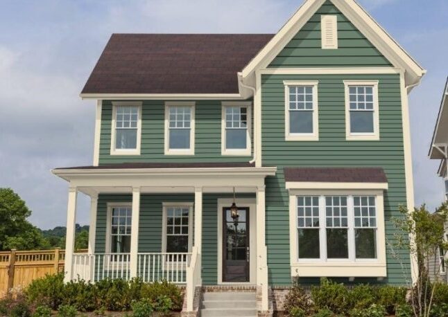 A green house with mauve and white windows 