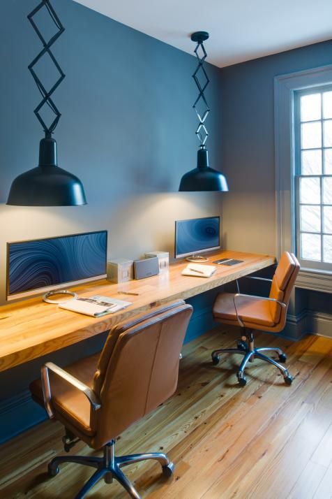 A dark office with leather chairs and floating deck