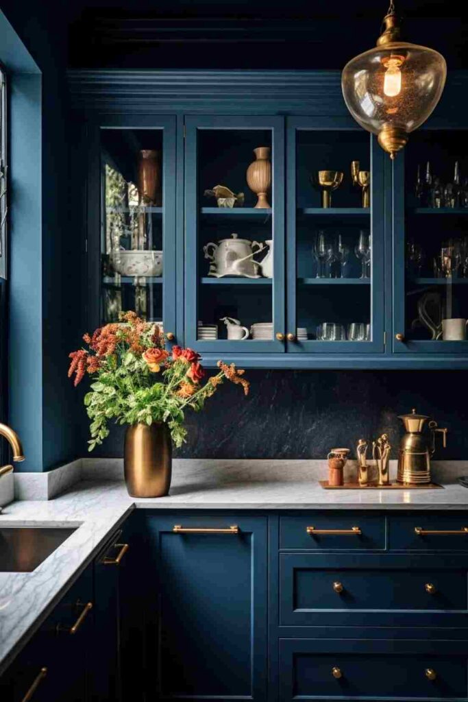 A navy blue cabinets with white countertop and vase on it