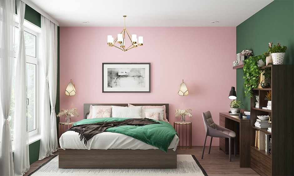 A pink and green bedroom with beige accents and wooden floor
