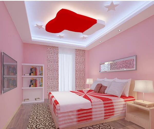 A white and pink bedroom with red pop with star and rug on the floor and lamp on the side table