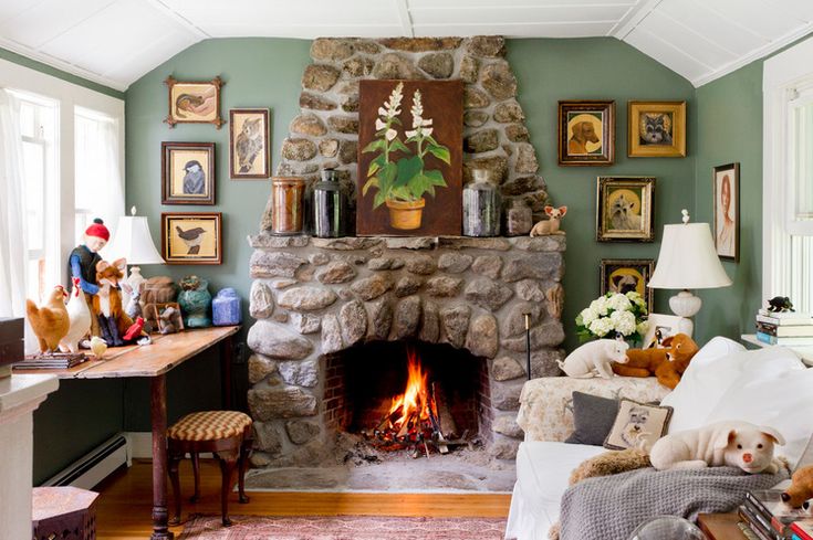 A living room with fireplace and frames on the wall