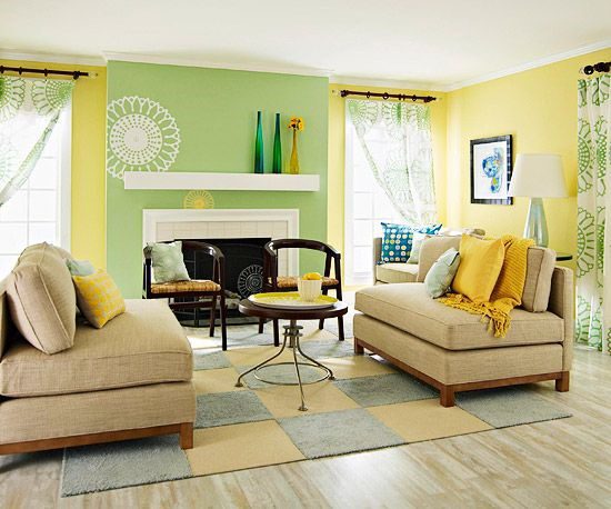 A sage green with yellow wall and sofa and wooden floor
