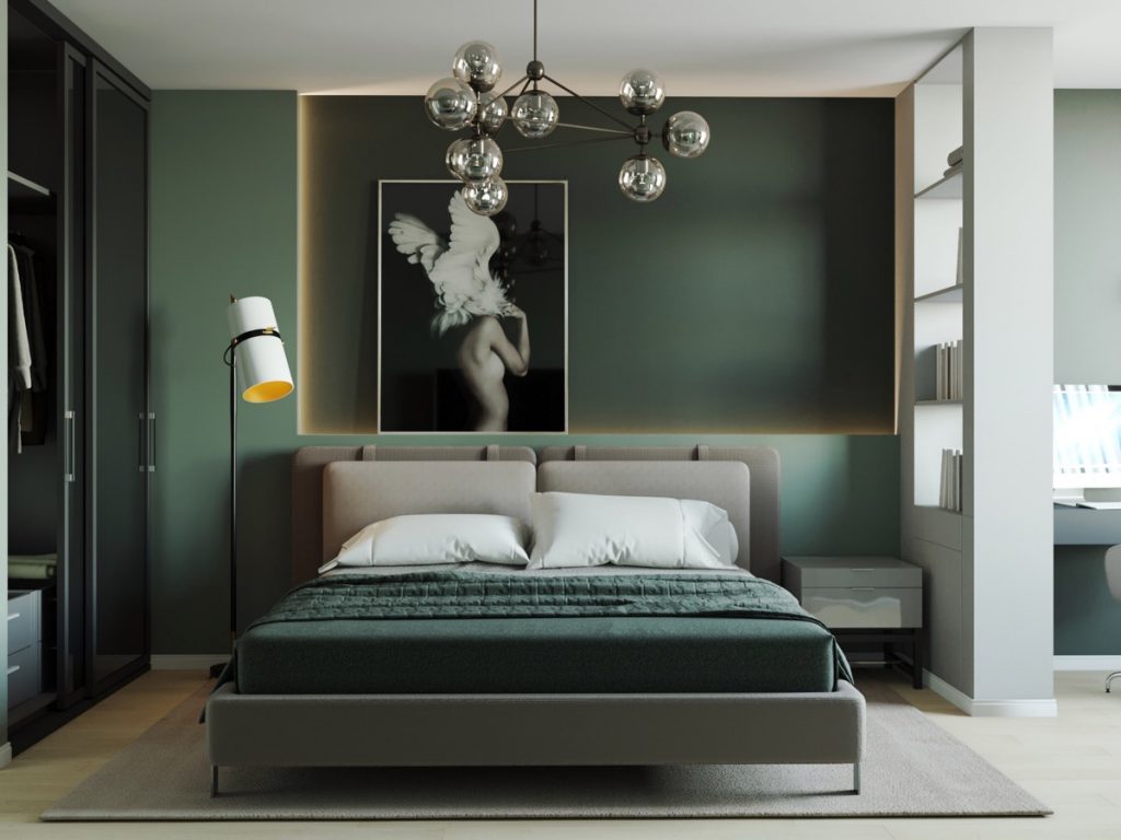 A sage green with grey bedding and lights above the wall