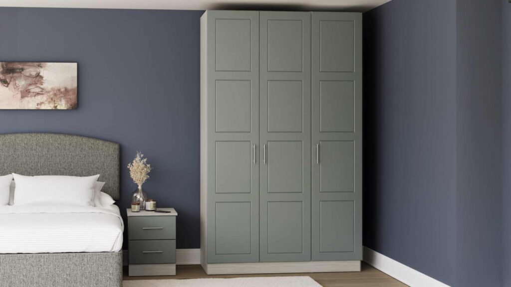 A sage green wardrobe in grey bedroom and grey bed with white blankets and pillow