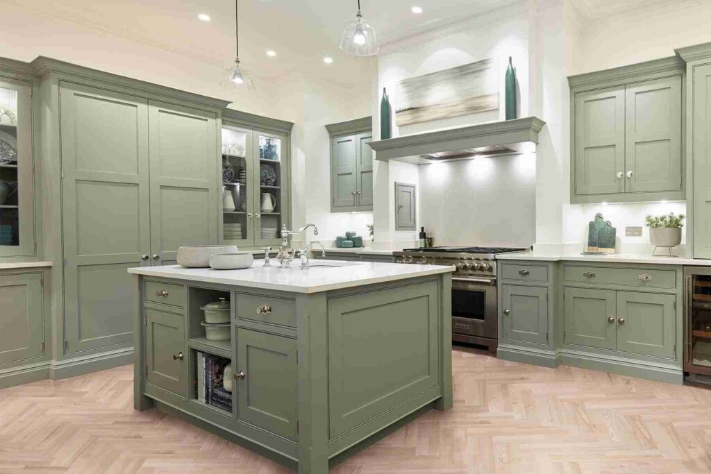A kitchen with Shaker-style cabinets and block and wooden floor
