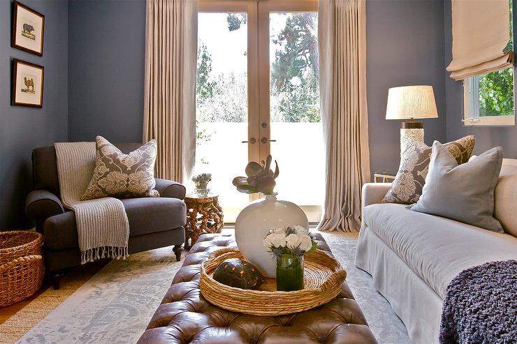 A blue living room with sofa and rug on the wooden floor and lamp on the side table