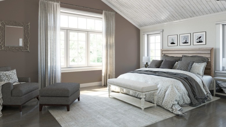 A bedroom with grey accents and wooden floor
