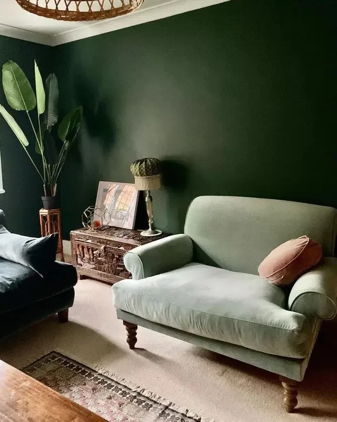 A sage green chair with beige accents