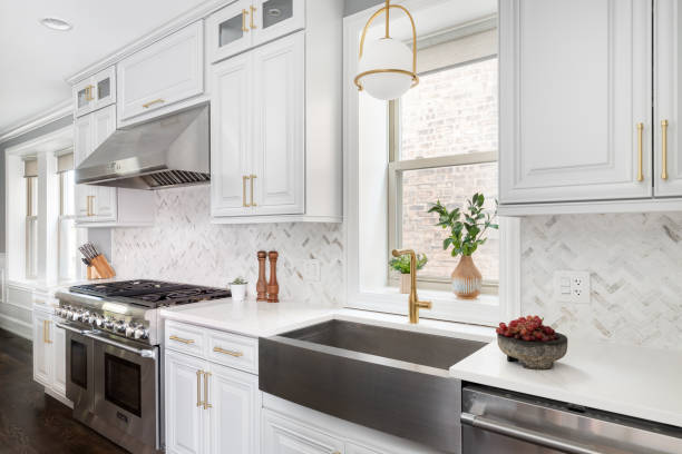 A white cabinets and grey sink