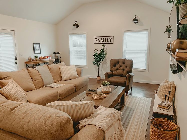 A small living room with lights and sofa and table and wooden floor and rug on it