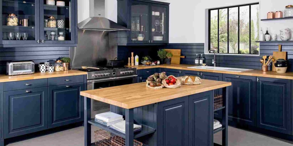 A kitchen with blue cabinets and Wooden butcher and glass windows