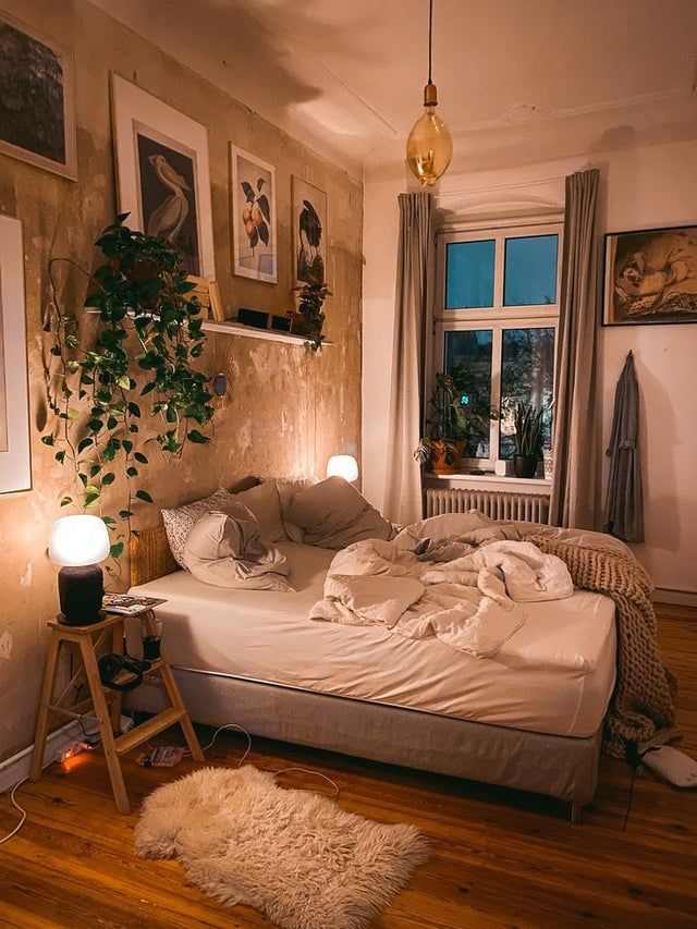 A bedroom with white framed windows ad wooden floor and lights in the bedroom
