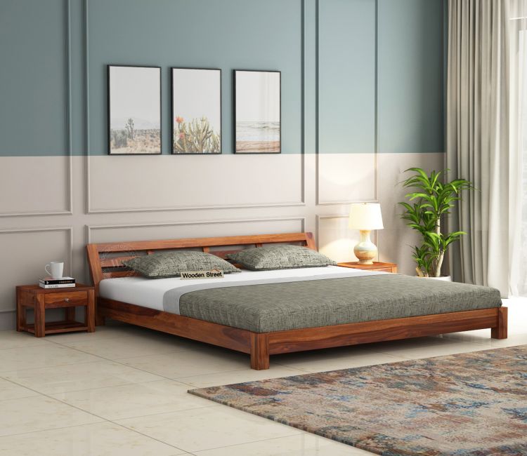 A bedroom with platform bed and rug on the floor and side table