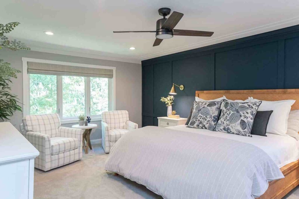 A grey and blue bedroom with sofa and white floor and wooden bedding and celling lights