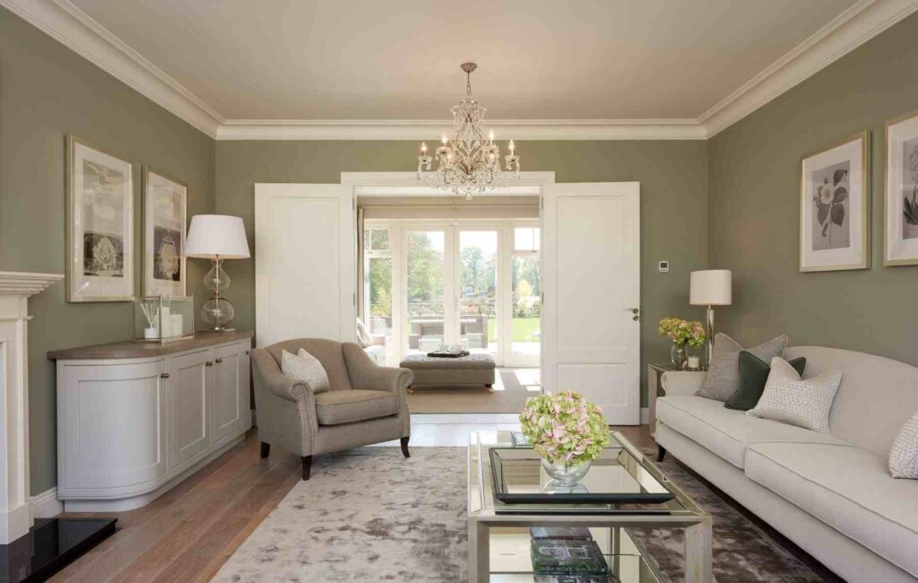 A eige and green room with wooden floor and sofa and table