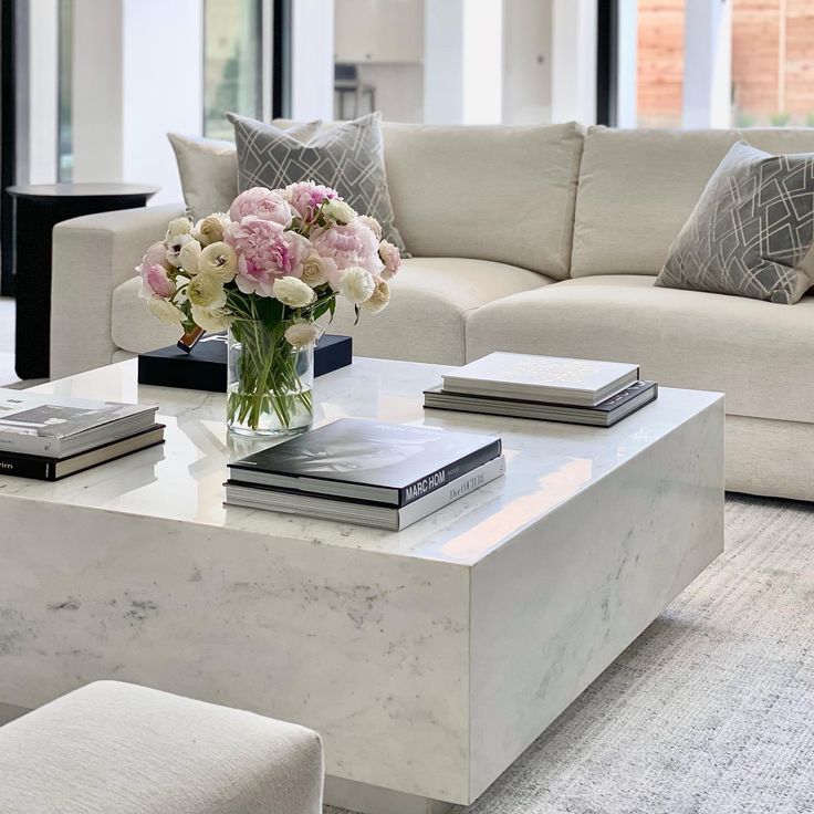A living room with sofa and marble table 