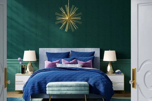 A green bedroom with blue blankets and white nightstand