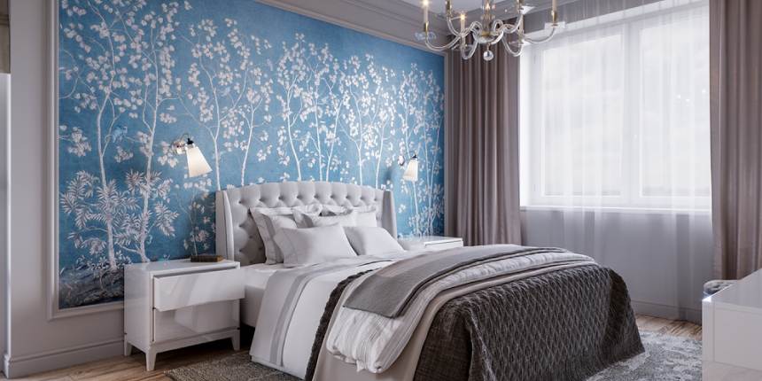 A grey bedroom with white and blue wallpaper and light on the wall