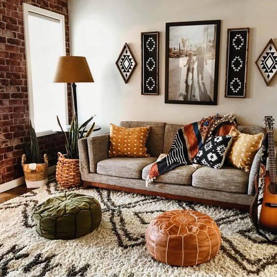 A small living room with rug on the floor and frames on the wall