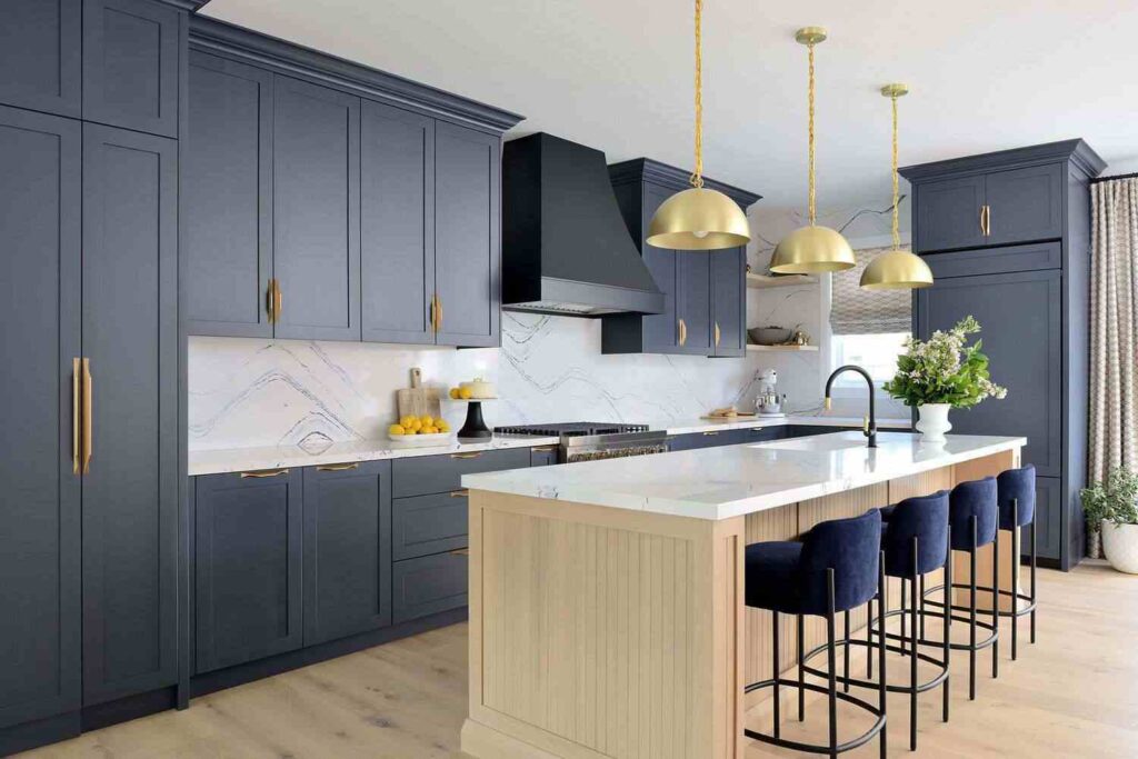 A kitchen with blue cabinets and wooden black and brass fixtures