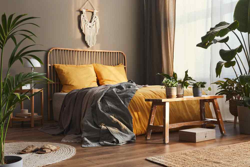A brown bedroom with plants and  wooden floor 
