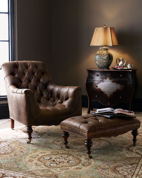 A brown leather chair in the bedroom with rug on the floor 