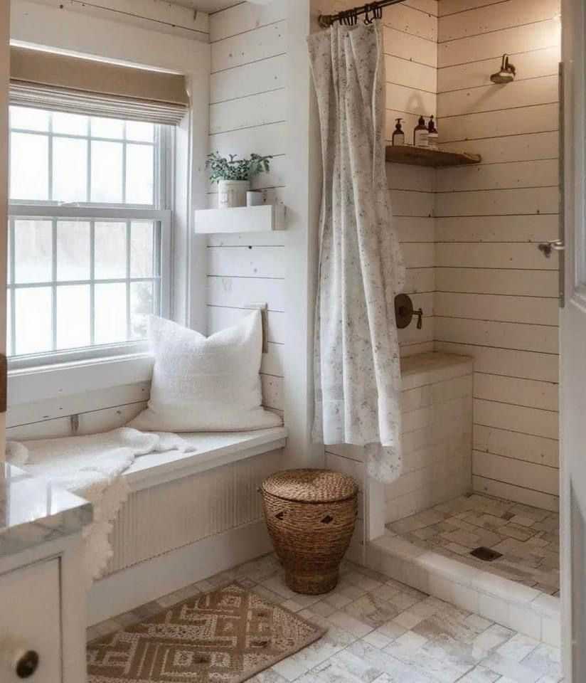 A preppy bathroom with built-in window seating  with white pillow